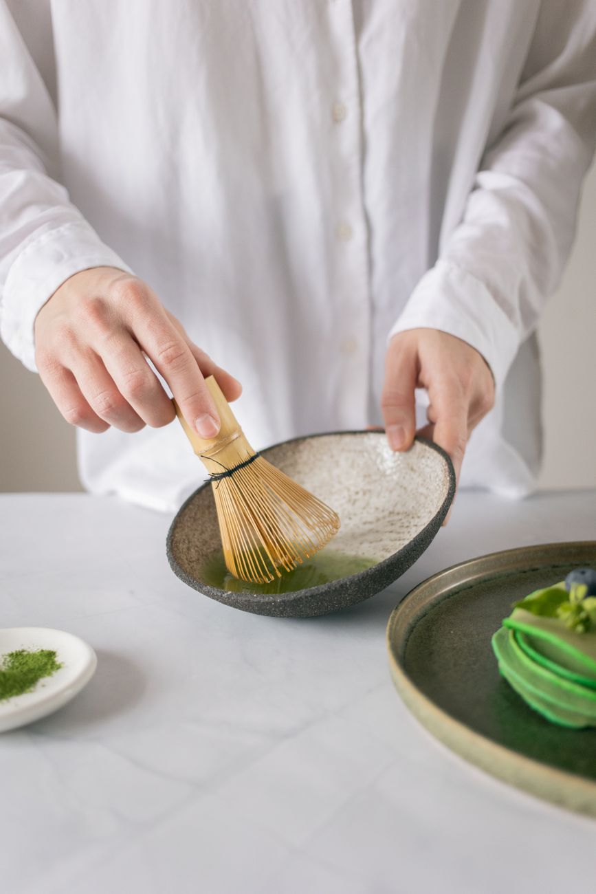 Traditional Japanese tea master preparing matcha