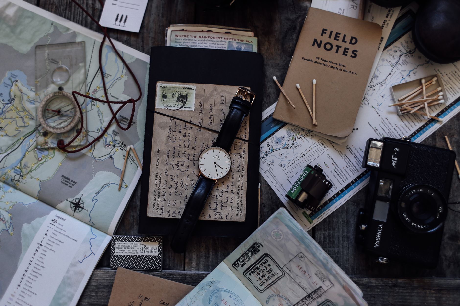 Handmade leather map and explorer notebook on timber table
